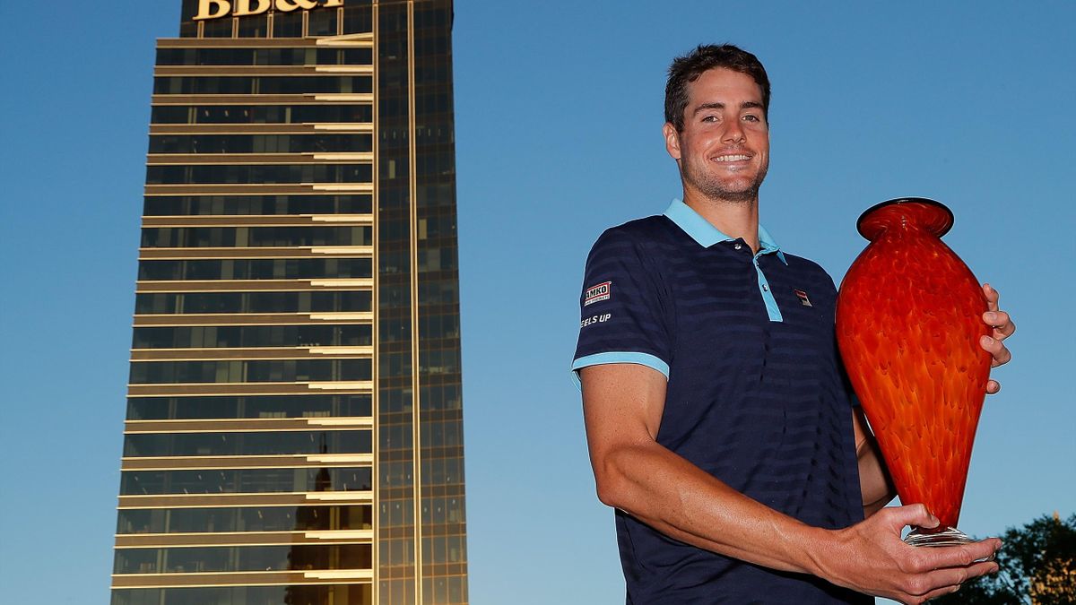 John Isner poses with the trophy after winning the BB&T Atlanta Open at Atlantic Station on July 30, 2017