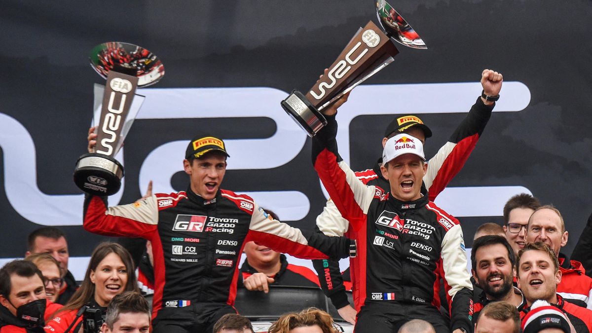 France's Sebastien Ogier (R) and co-driver France's Julien Ingrassia (L) celebrate their 8th WRC Champion title with their team on November 21, 2021 after the ACI Rally Monza 2021 of the FIA World Rally Championship at the Monza racetrack, Italy