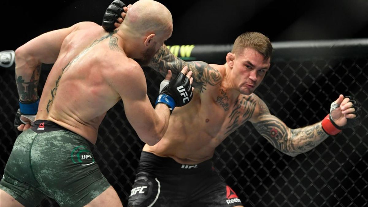 Dustin Poirier punches Conor McGregor of Ireland in a lightweight fight during the UFC 257 event inside Etihad Arena on UFC Fight Island on January 23, 2021 in Abu Dhabi,