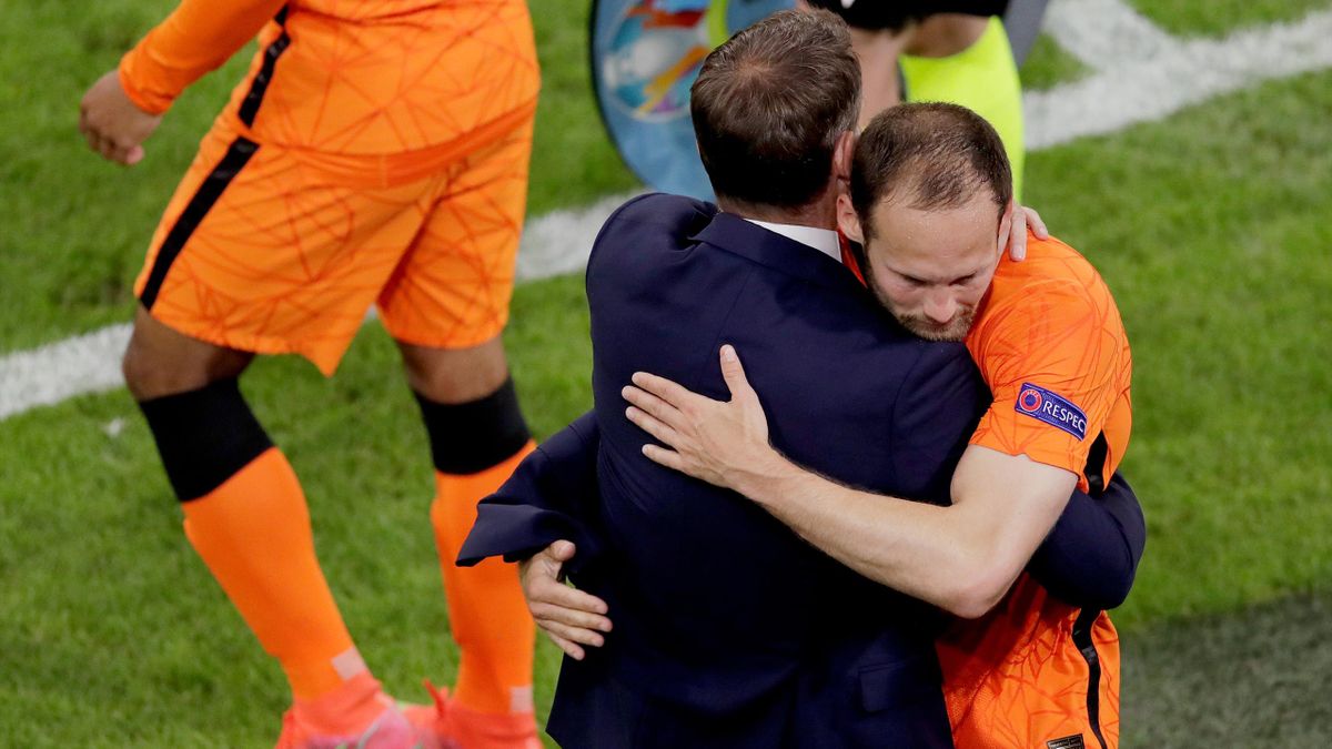 An emotional Daley Blind hugs Netherlands boss Frank de Boer after playing a day after his friend Christian Eriksen suffered a cardiac arrest