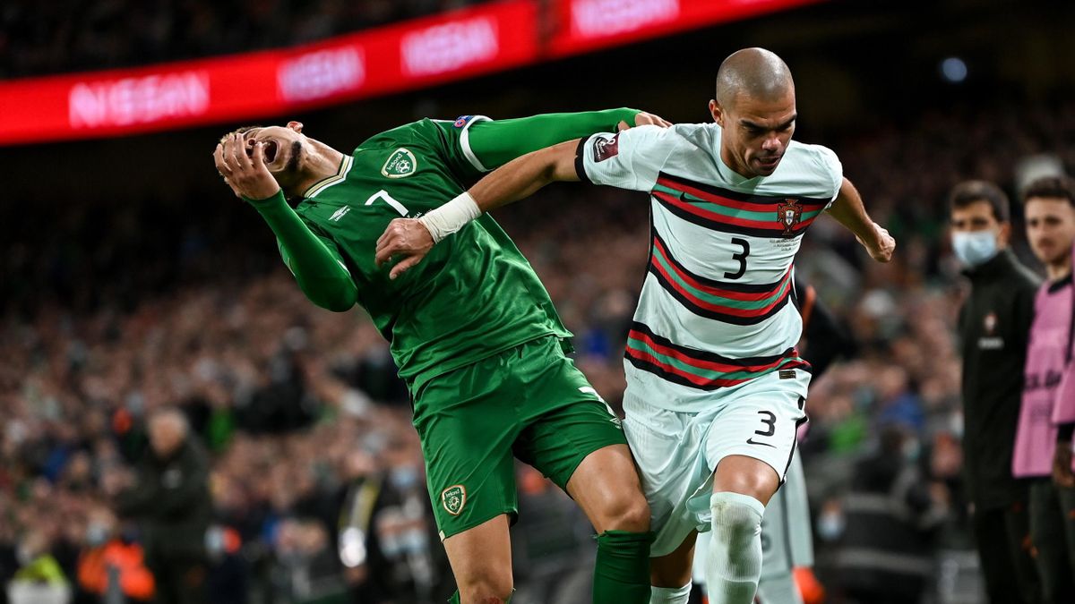Pepe of Portugal fouls Callum Robinson of Republic of Ireland before being shown a second yellow card