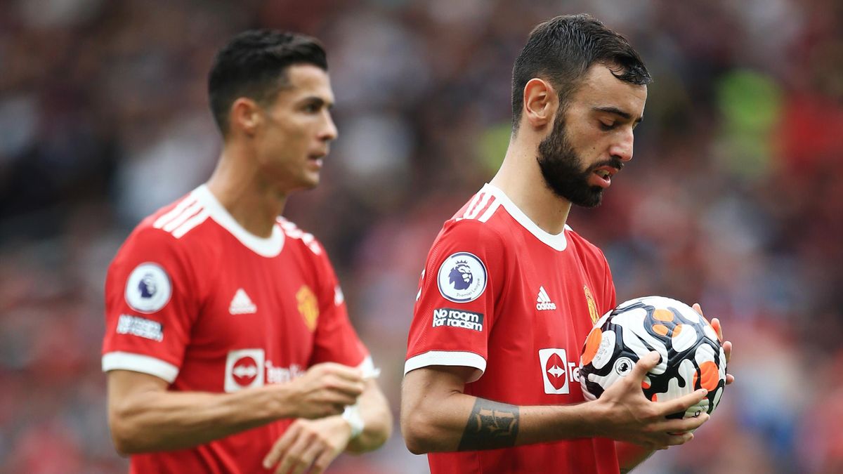 Bruno Fernandes of Manchester United (R) prepares to take his penalty as Cristiano Ronaldo of Manchester United looks on during the Premier League match between Manchester United and Aston Villa at Old Trafford on September 25, 2021 in Manchester, England