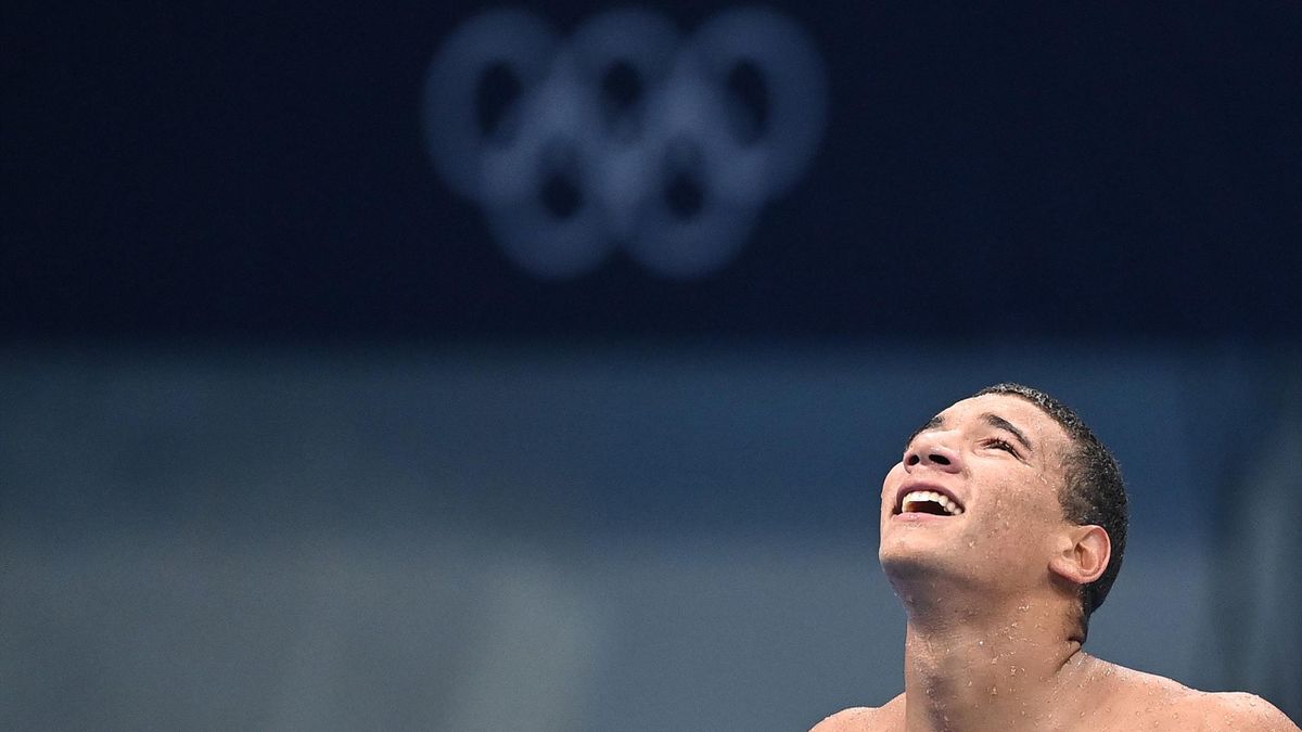 Tunisia's Ahmed Hafnaoui celebrates after winning the final of the men's 400m freestyle swimming event during the Tokyo 2020 Olympic Games at the Tokyo Aquatics Centre in Tokyo on July 25, 2021