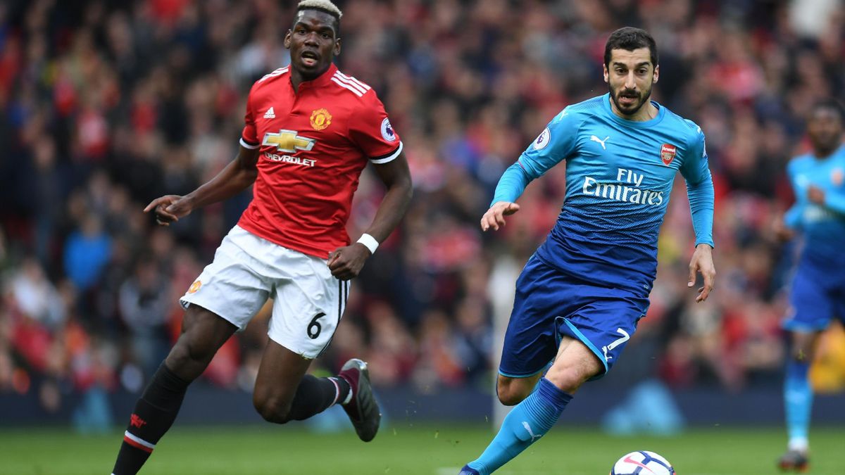 Arsenal's Armenian midfielder Henrikh Mkhitaryan (R) vies with Manchester United's French midfielder Paul Pogba during the English Premier League football match between Manchester United and Arsenal at Old Trafford