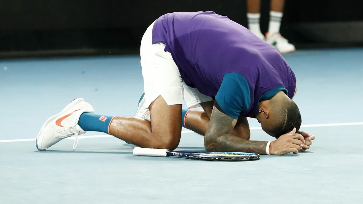Nick Kyrgios of Australia collapses to the ground after winning his Men's Singles second round match against Ugo Humbert of France during day three of the 2021 Australian Open at Melbourne Park