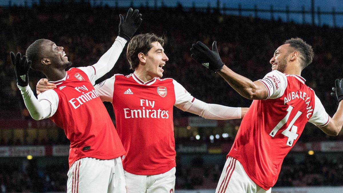 Pierre-Emerick Aubameyang of Arsenal FC celebrate with his team mates Nicolas Pepe, Héctor Bellerin after scoring his 2nd and his team's 3rd goal during the Premier League match between Arsenal FC and Everton FC at Emirates Stadium on February 23, 2020 in