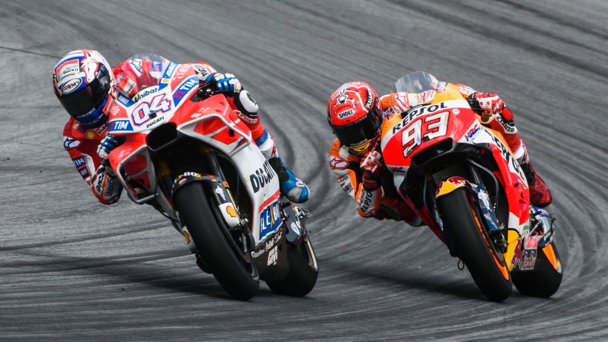 Ducati Team's Italian rider Andrea Dovizioso (L) and Repsol Honda Team's Spanish rider Marc Marquez compete during the MotoGP Austrian Grand Prix