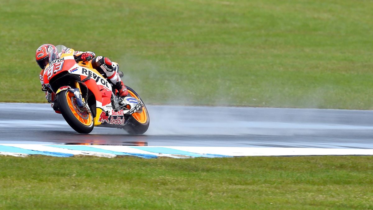 Repsol Honda Team's Spanish rider Marc Marquez powers through the wet circuit during a practice session of the MotoGP class at the Australian Grand Prix at Phillip Island on October 22, 2016