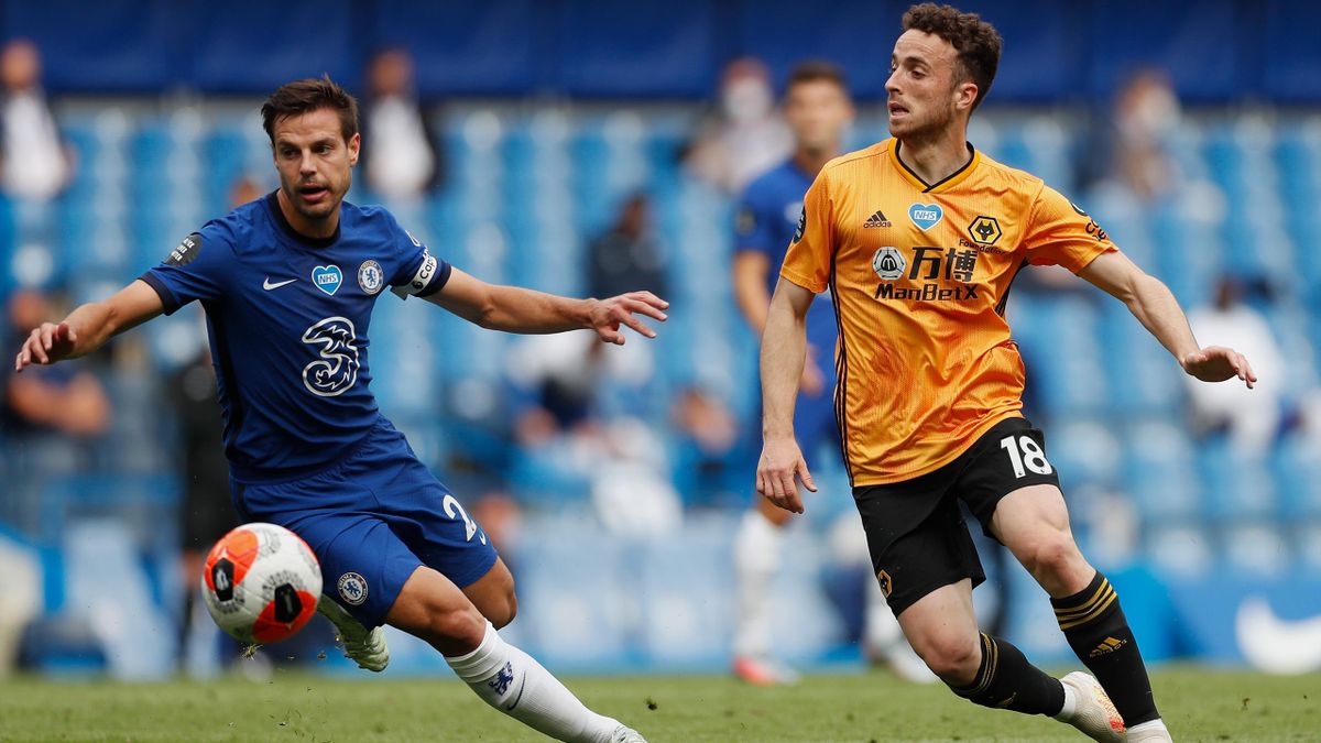 Cesar Azpilicueta of Chelsea and Diogo Jota of Wolverhampton Wanderers compete for the ball during the Premier League match between Chelsea FC and Wolverhampton Wanderers at Stamford Bridge on July 26, 2020 in London, England. Football Stadiums around Eu
