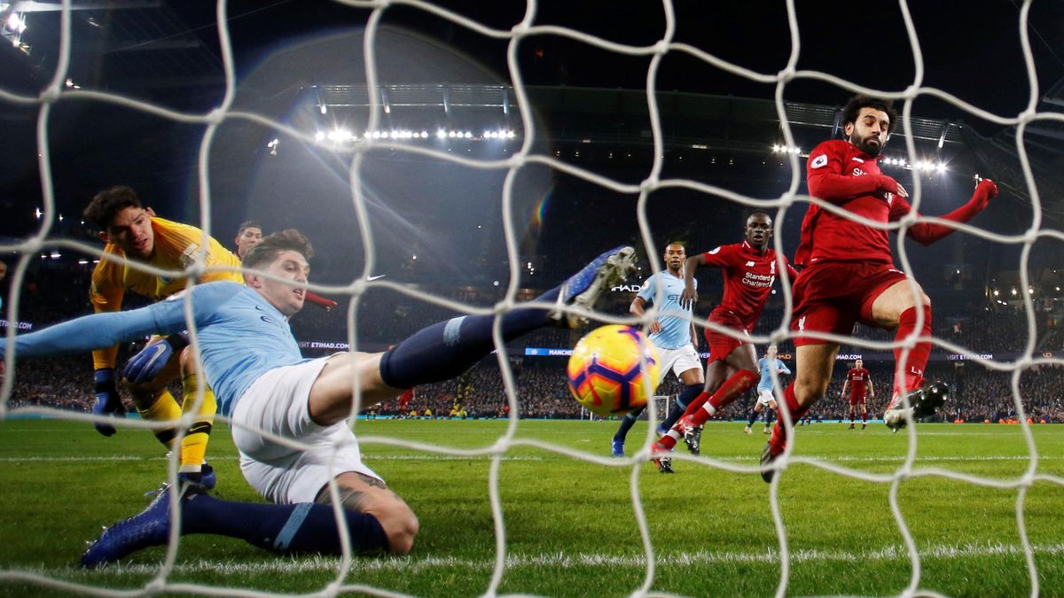 Manchester City's John Stones clears the ball off the line away from Liverpool's Mohamed Salah