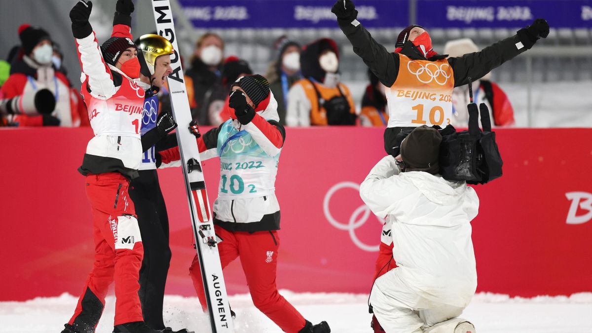 Austria celebrate after Marcus Fettner produced a final jump to win gold at the Winter Olympics