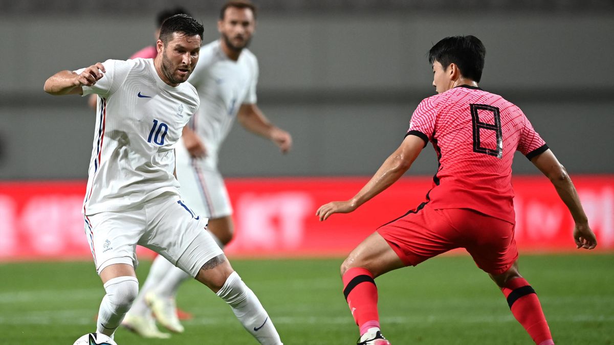 France's Andre-Pierre Gignac (L) is challenged by South Korea's Kim Dong-hyun (R) during their friendly football match in Seoul on July 16, 2021, ahead of the 2020 Tokyo Olympic Games.