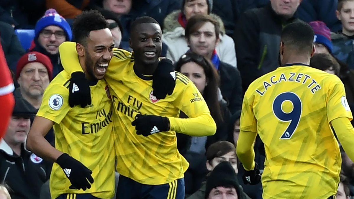 Arsenal's Gabonese striker Pierre-Emerick Aubameyang (L) celebrates scoring his team's first goal with Arsenal's French-born Ivorian midfielder Nicolas Pepe during the English Premier League football match between Crystal Palace and Arsenal at Selhurst Pa