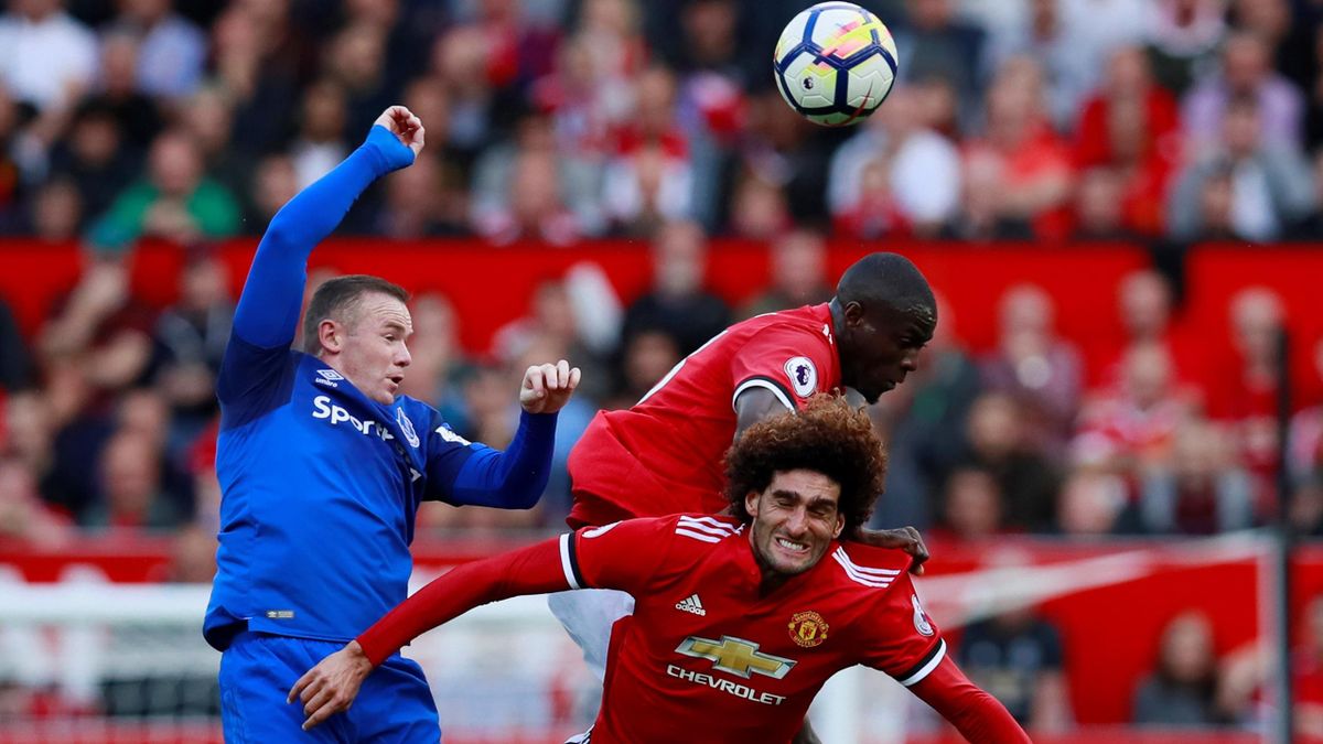 Everton's Wayne Rooney in action with Manchester United's Marouane Fellaini and Eric Bailly