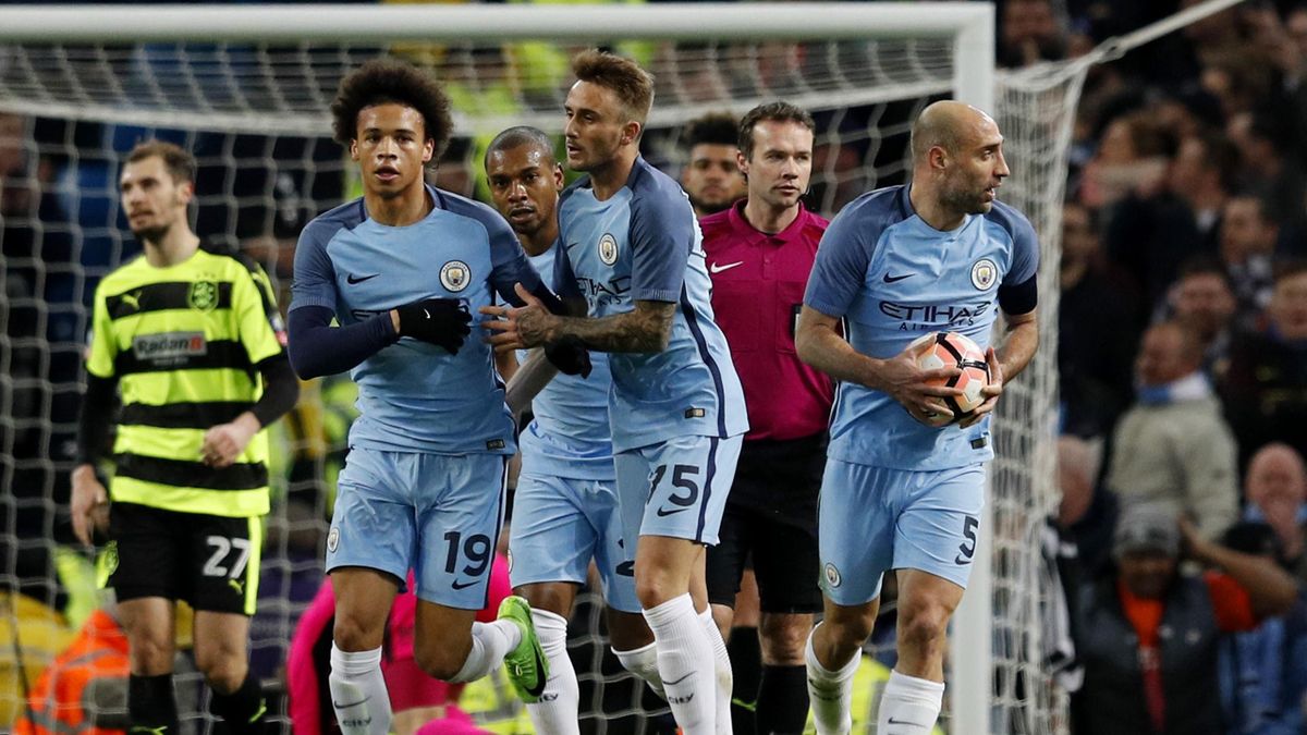 Manchester City's Leroy Sane celebrates scoring their first goal with teammates