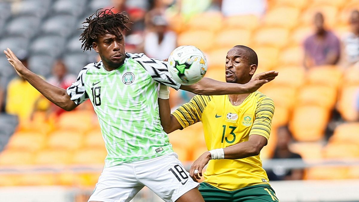 South Africa's Tiyani Mabunda (R) tackles Nigeria's Alexander Iwobi during the African Cup of Nations qualifier match between South Africa and Nigeria on November 17, 2018 at Soccer City Stadium in Johannesburg, South Africa.