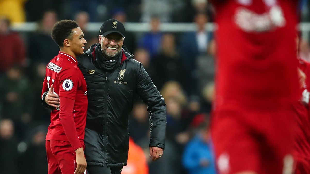 Trent Alexander-Arnold of Liverpool and Jurgen Klopp manager / head coach of Liverpool celebrate at full time during the Premier League match between Newcastle United and Liverpool FC at St. James Park on May 4, 2019 in Newcastle upon Tyne, United Kingdom