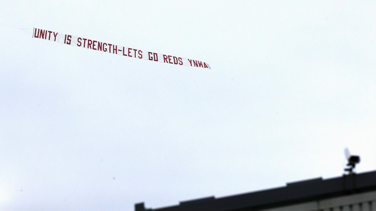 A banner saying "Unity is strength - Lets go reds YNWA" is flown over the stadium by a small plane
