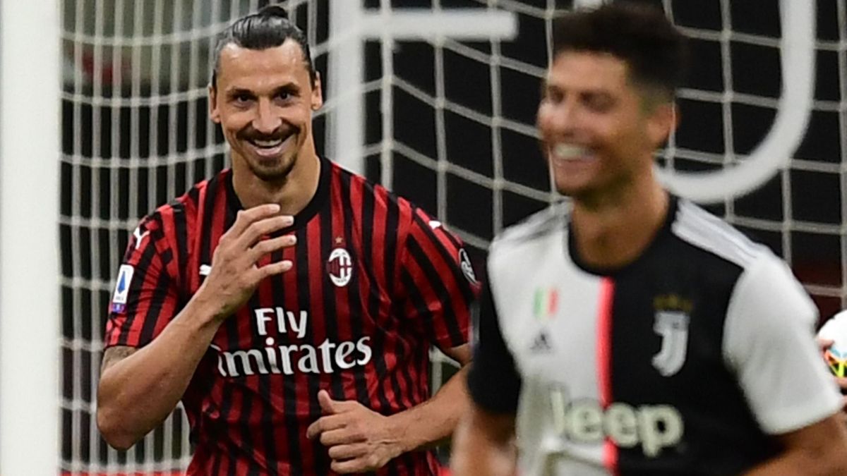 Zlatan Ibrahimovic celebrates scoring for AC Milan as Cristiano Ronaldo looks on.