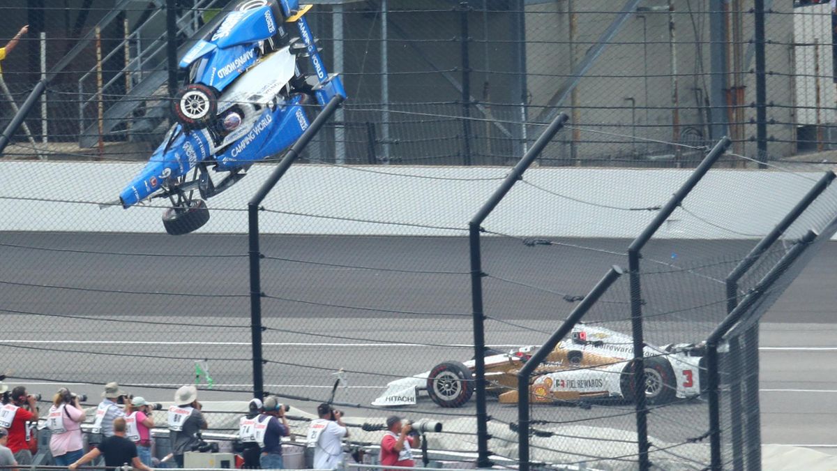 IndyCar Series driver Scott Dixon (9) goes airborne and crashes in front of Helio Castroneves (3)