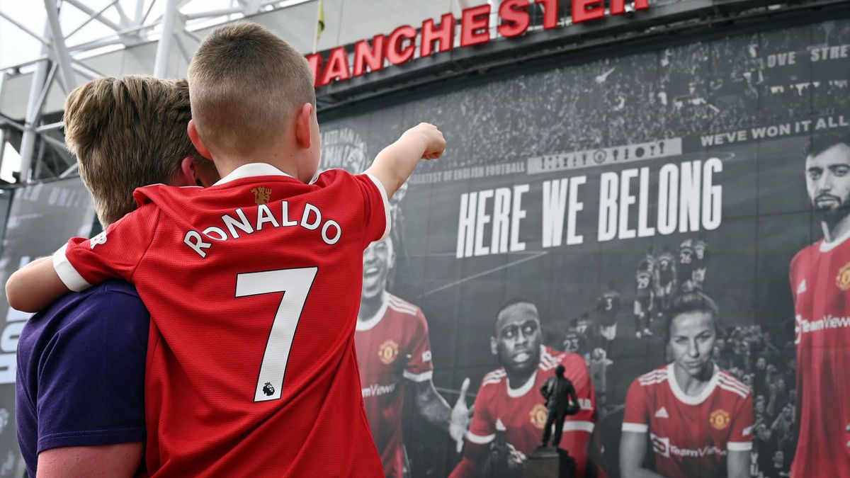 A young Manchester United fan with a Cristiano Ronaldo "7" shirt outside Old Trafford