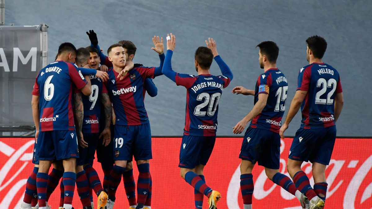 Levante's Spanish forward Roger Marti (2L) is congratulated after scoring his team's second goal during the Spanish league football match Real Madrid CF against Levante UD at the Alfredo di Stefano stadium in Valdebebas, on the outskirts of Madrid on Janu