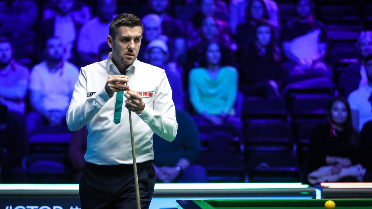 Mark Selby of England chalks the cue in the group match between Mark Selby of England and Rebecca Kenna of England vs Neil Robertson of Australia and Nutcharut Wongharuthai of Thailand on day one of BetVictor World Mixed Doubles Championship at Marshall