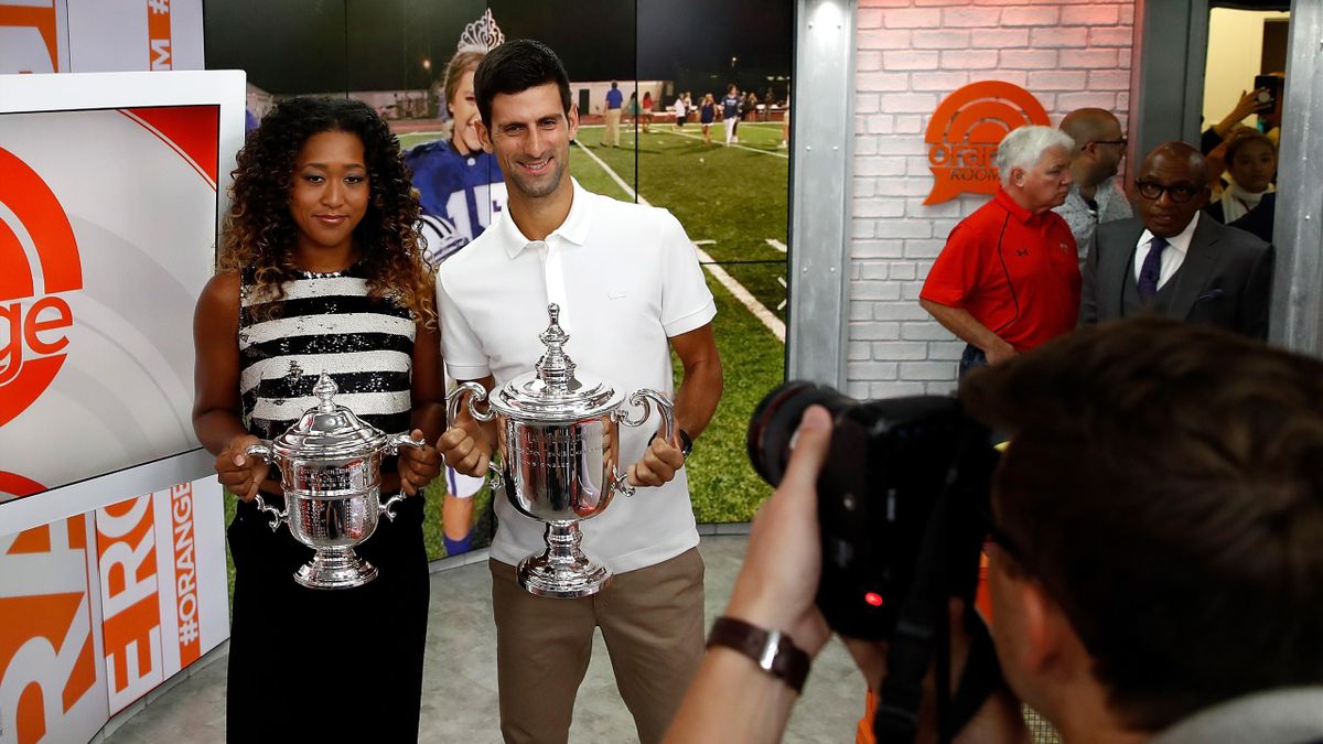 Novak Djokovic of Serbia and Naomi Osaka of Japan hold their winners trophies at NBC's TODAY Show on September 10, 2018 in New York City