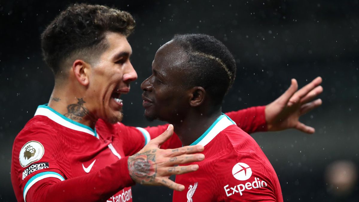 Sadio Mane of Liverpool celebrates with teammate Roberto Firminho