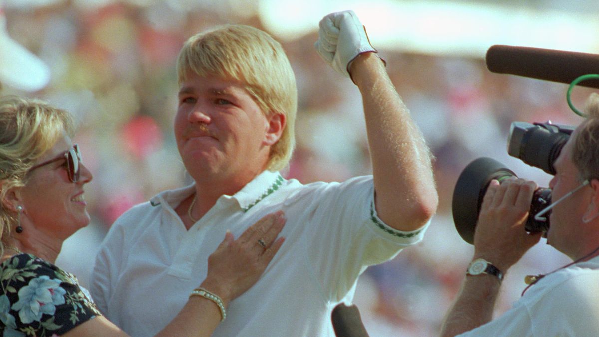 PGA Champion John Daly and Betty Fulton celebrate on the 18th green after Daly won the 73rd US PGA Championship at Crooked Stick Country Club.