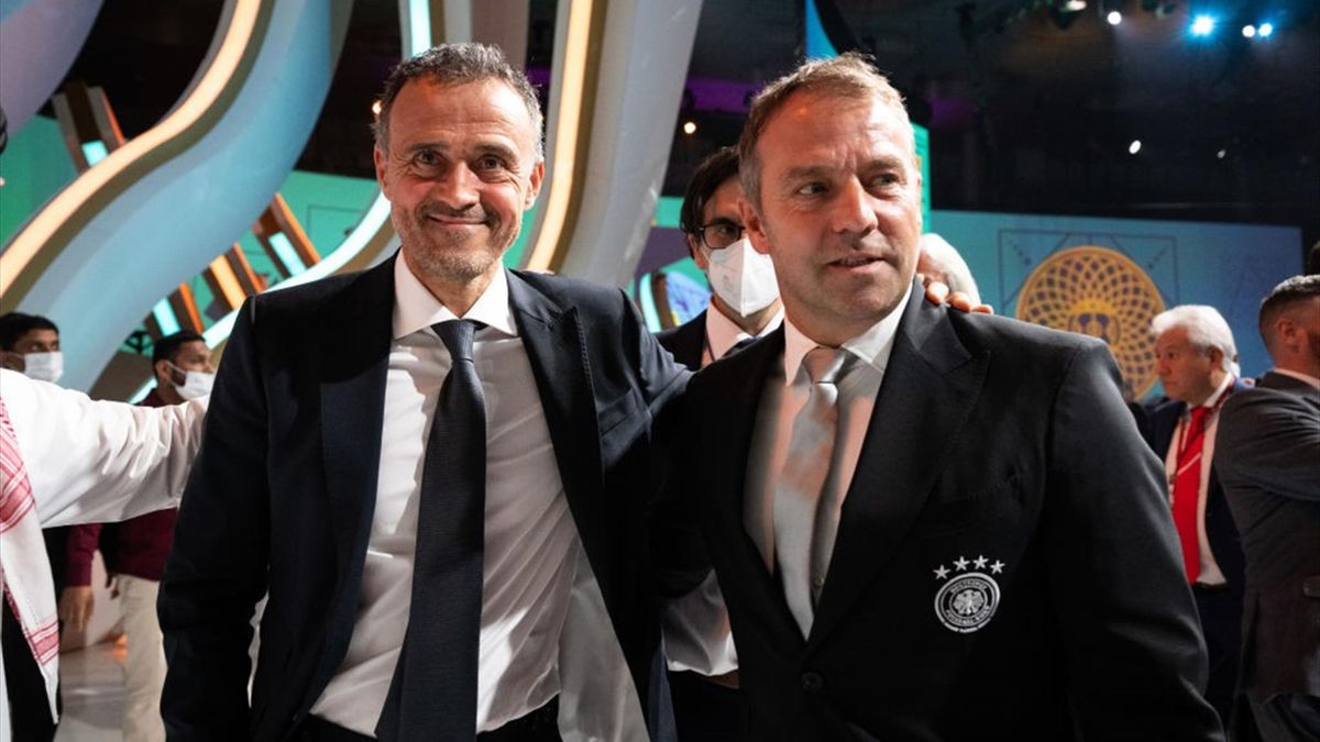 Hansi Flick, Head Coach of Germany, poses with Luis Enrique (L), Head Coach of Spain, for a group photo at Doha Exhibition Center