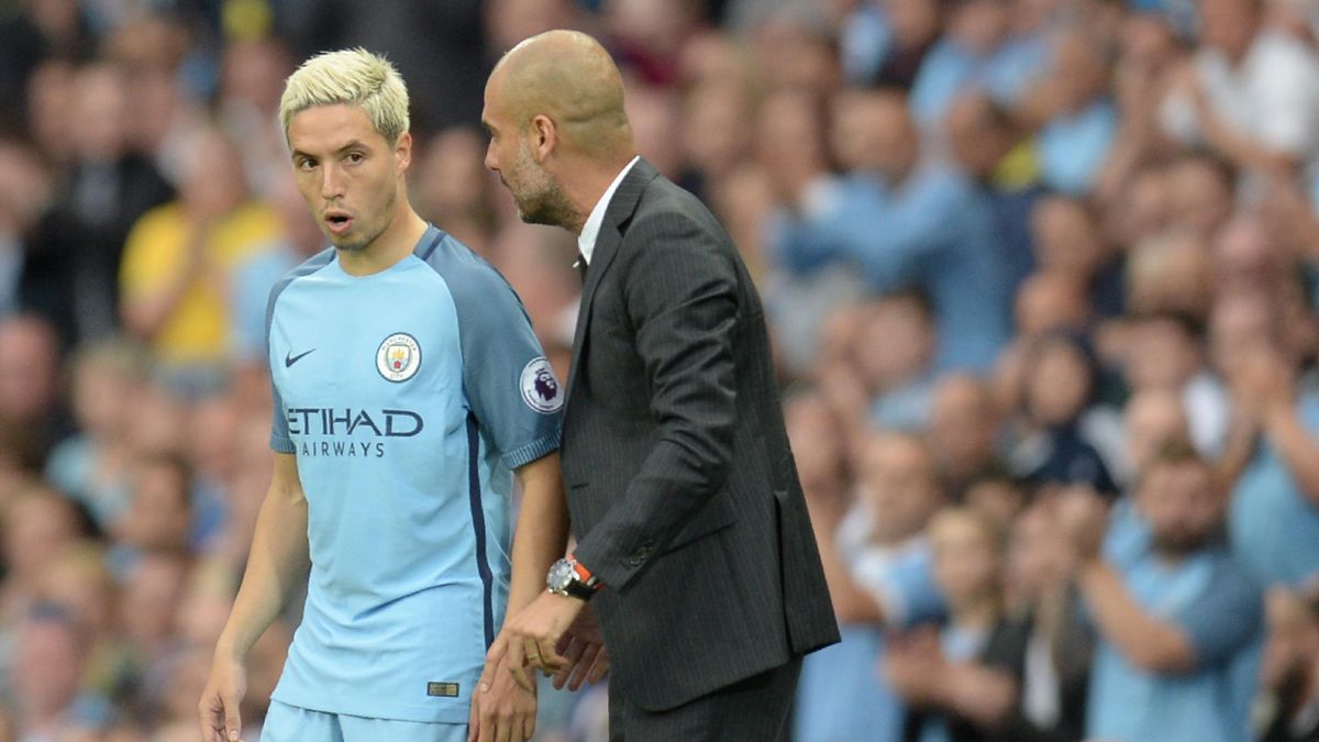 Manchester City's Spanish manager Pep Guardiola talks to Manchester City's French midfielder Samir Nasri (L) as he prepares to come on during the English Premier League football match between Manchester City and West Ham United at the Etihad Stadium in Ma