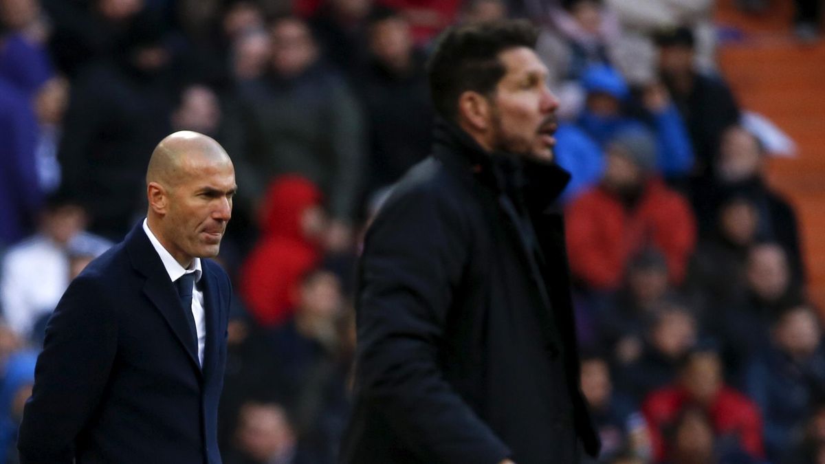 Real Madrid's coach Zinedine Zidane reacts next to Atletico Madrid's coach Diego "Cholo" Simeone