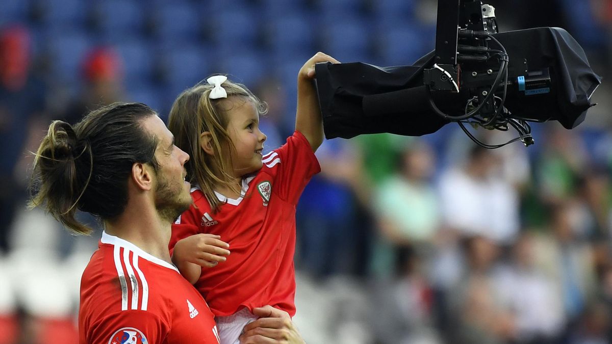 Wales' forward Gareth Bale (L) and his daughter Alba Viola are pictured following the Euro 2016 round of sixteen football match Wales vs Northern Ireland, on June 25, 2016 at the Parc des Princes stadium in Paris.