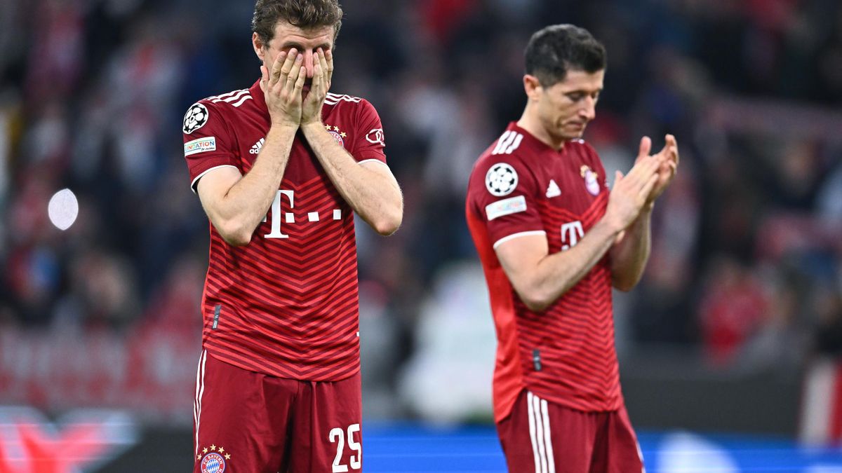 Thomas Mueller (L) and Robert Lewandowski (R) of Bayern are looking dejected after the UEFA Champions League Quarter Final Leg Two match between Bayern München and Villarreal CF at Football Arena Munich on April 12, 2022 in Munich, Germany.