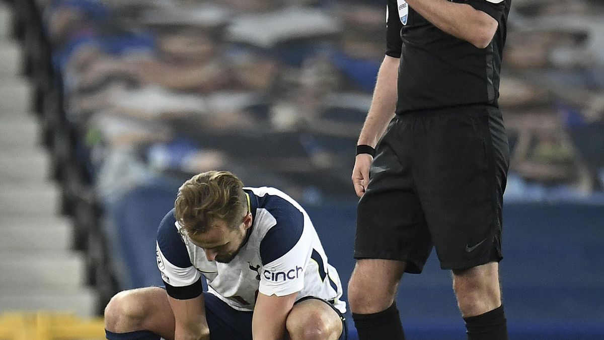 Harry Kane of Tottenham Hotspur holds his foot following an injury during the Premier League match between Everton and Tottenham Hotspur at Goodison Park on April 16, 2021 in Liverpool