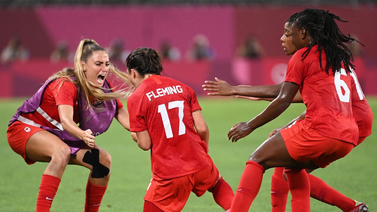 Canada's midfielder Jessie Fleming (C) celebrates after scoring the opening goal
