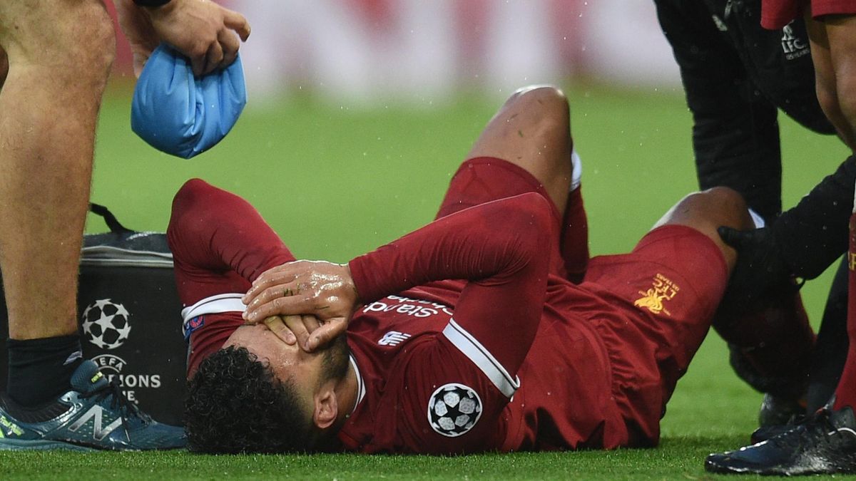 Liverpool's English midfielder Alex Oxlade-Chamberlain reacts after picking up an injury during the UEFA Champions League first leg semi-final football match between Liverpool and Roma at Anfield stadium in Liverpool, north west England on April 24, 2018