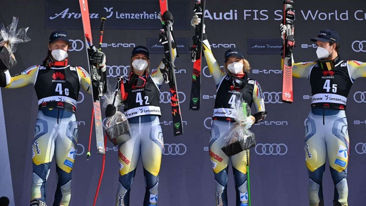 First-placed Norway's team (from L) Leif Kristian Nestvold-Haugen, Kristina Riis-Johannessen, Kristin Lysdahl and Sebastian Foss-Solevaag celebrate on the podium during the trophy ceremony after competing in the Team Parallel event during the FIS Alpine s