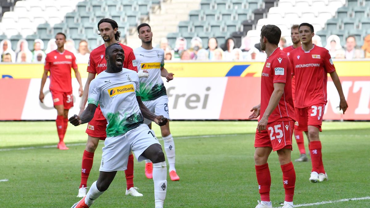 Marcus Thuram (L) celebrates after scoring the 2-0 during the German first division Bundesliga football match Borussia Moenchengladbach v Union Berlin in Moenchengladbach, western Germany, on 31 May, 2020
