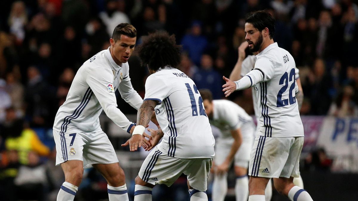 Real Madrid's Cristiano Ronaldo (L) celebrates with team mates Marcelo (C) and Francisco "Isco" Alarconafter scoring a goal.