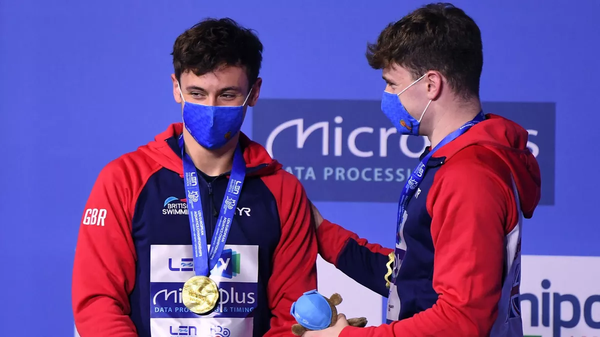 Gold medallists Great Britain's Matthew Lee (L) and Great Britain's Thomas Daley pose on the podium after the Men's Synchronised 10m Platform Diving event
