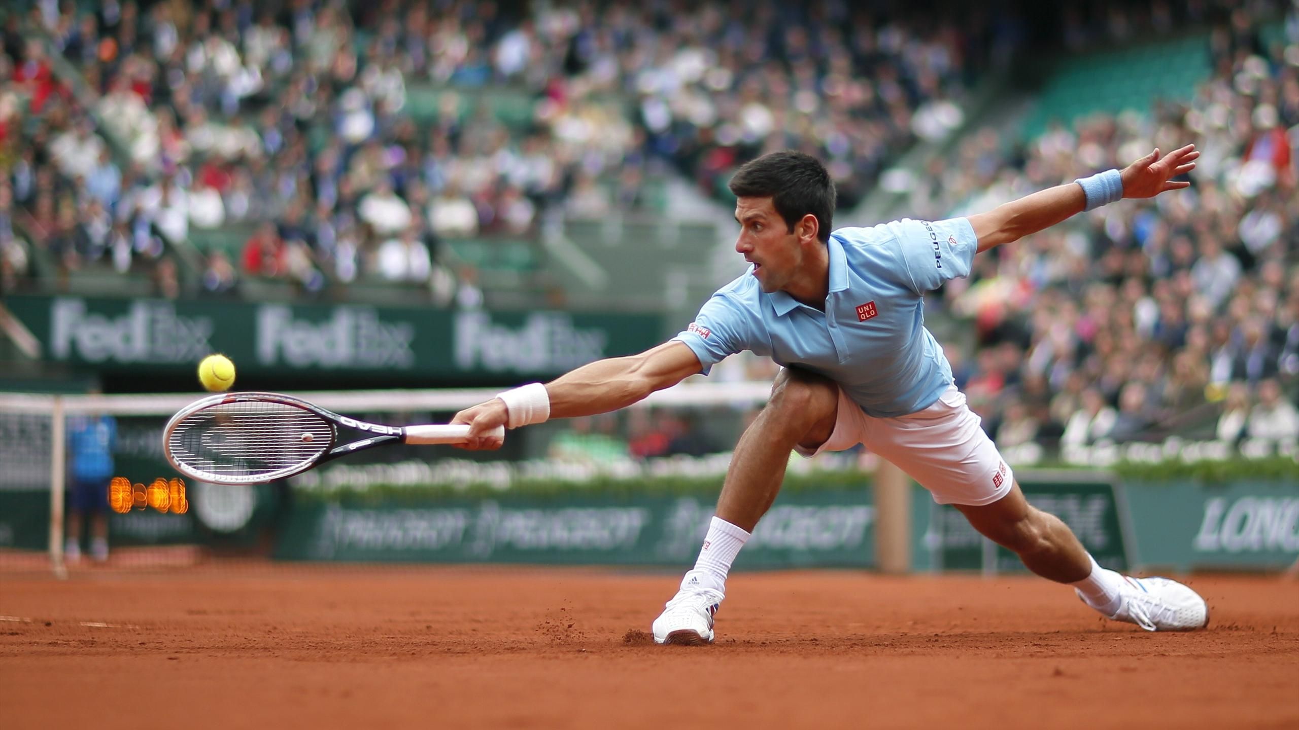 Funny man Djokovic slithers, Nadal cruises at damp Roland Garros