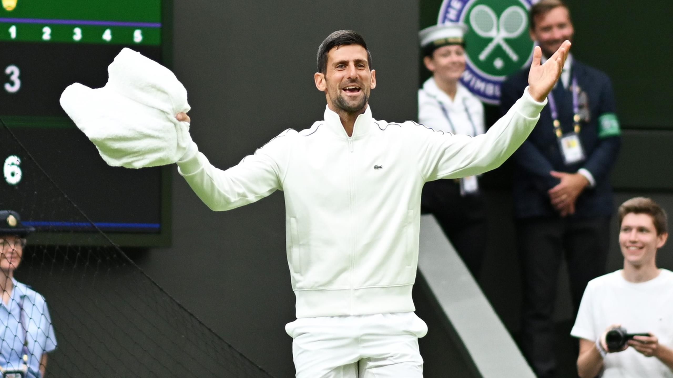 Novak Djokovic helps dry damp court after lengthy delay to first-round Wimbledon match against Pedro Cachin