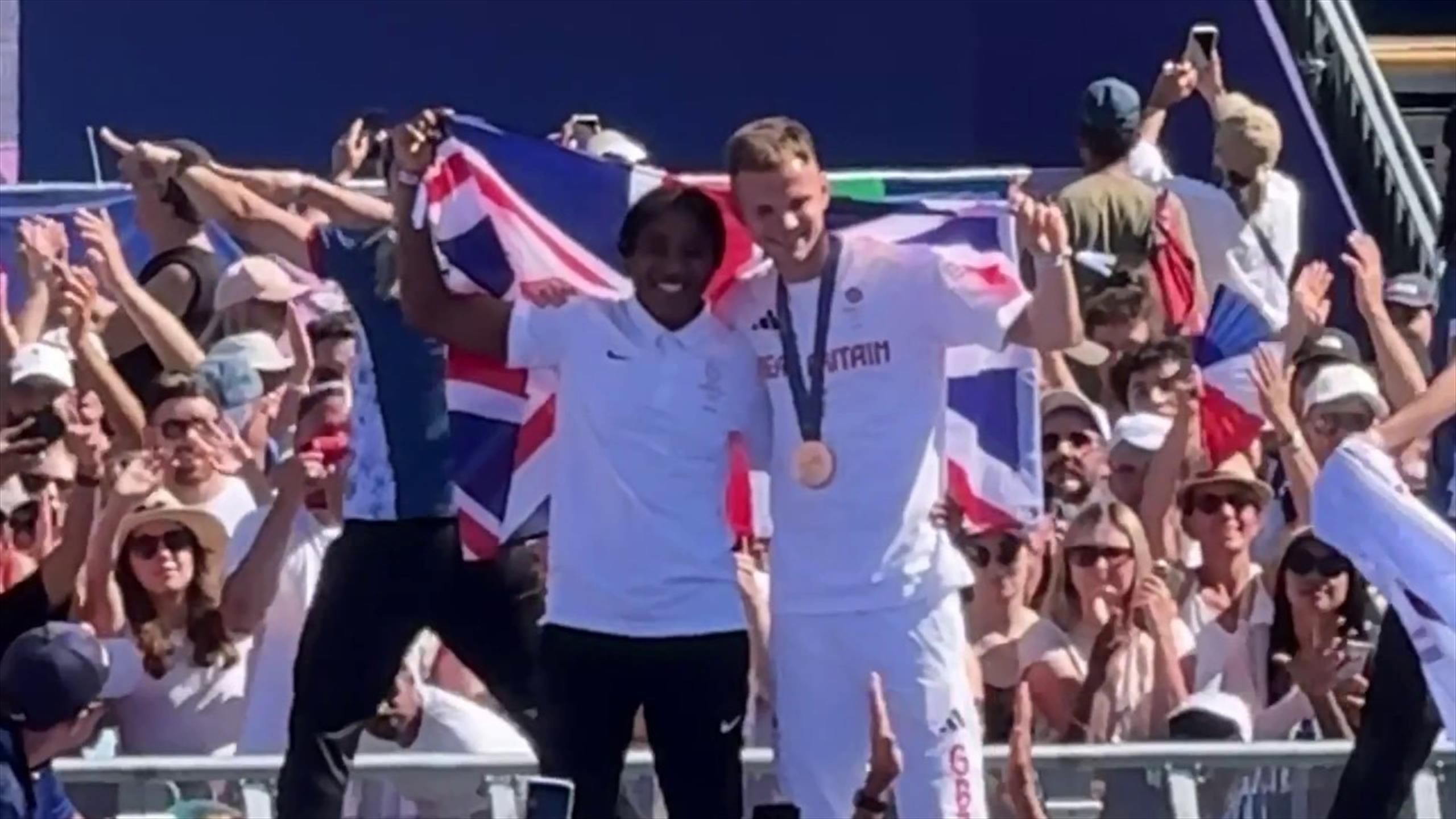 Team GB's Lewis Richardson shares his British flag with Cindy Ngamba