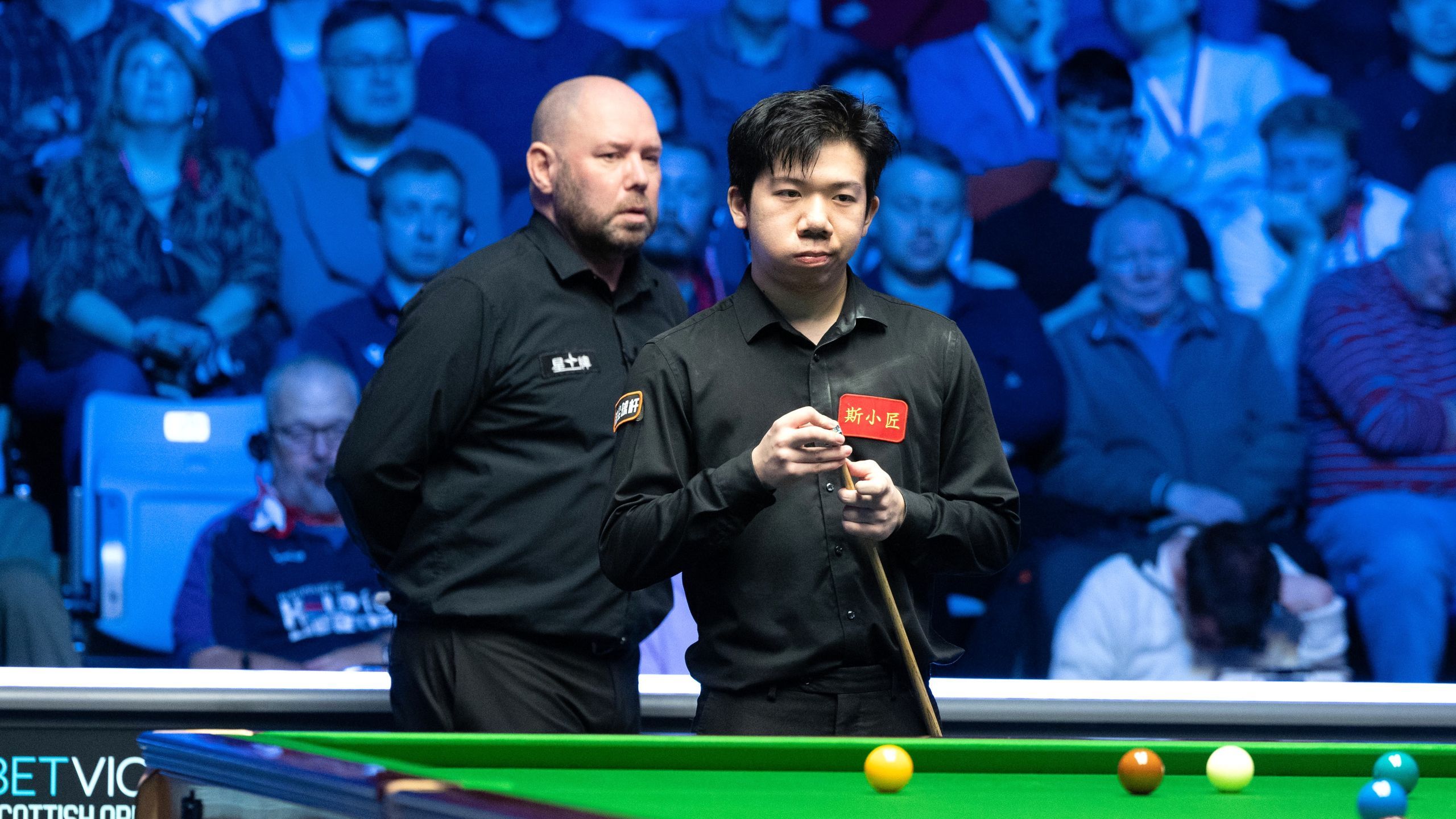 Unusual moment Lei Peifan checks with referee after ball takes an age