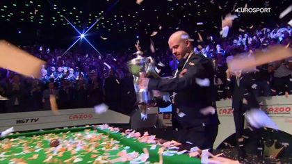 Brecel holds trophy aloft after making history in winning first world title