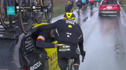 Watch funny moment as Evenepoel takes an age getting jacket on, eventually requiring assistance!