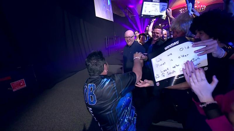 Maria O’Brien takes a tumble during her walk on at the World Darts Federation at Frimley Green