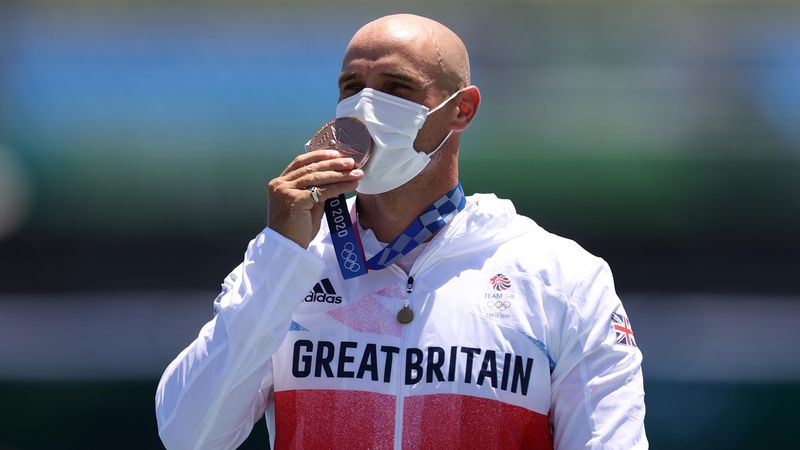 Sealed with a kiss: Heath receives bronze after photo-finish